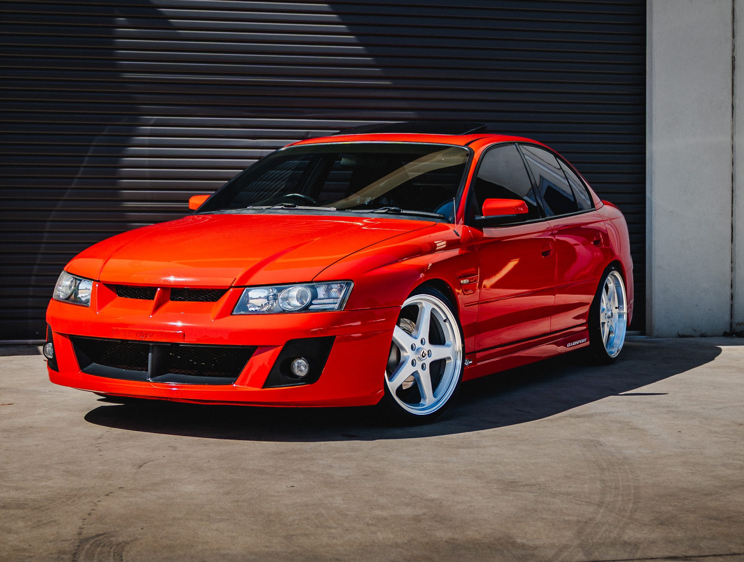 Red ClubSport photographed outside a garage